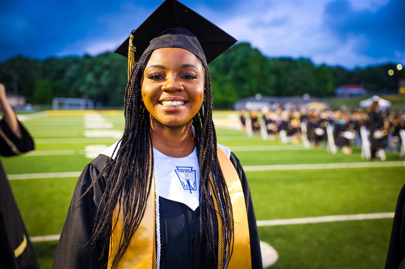 Students graduate on a football field